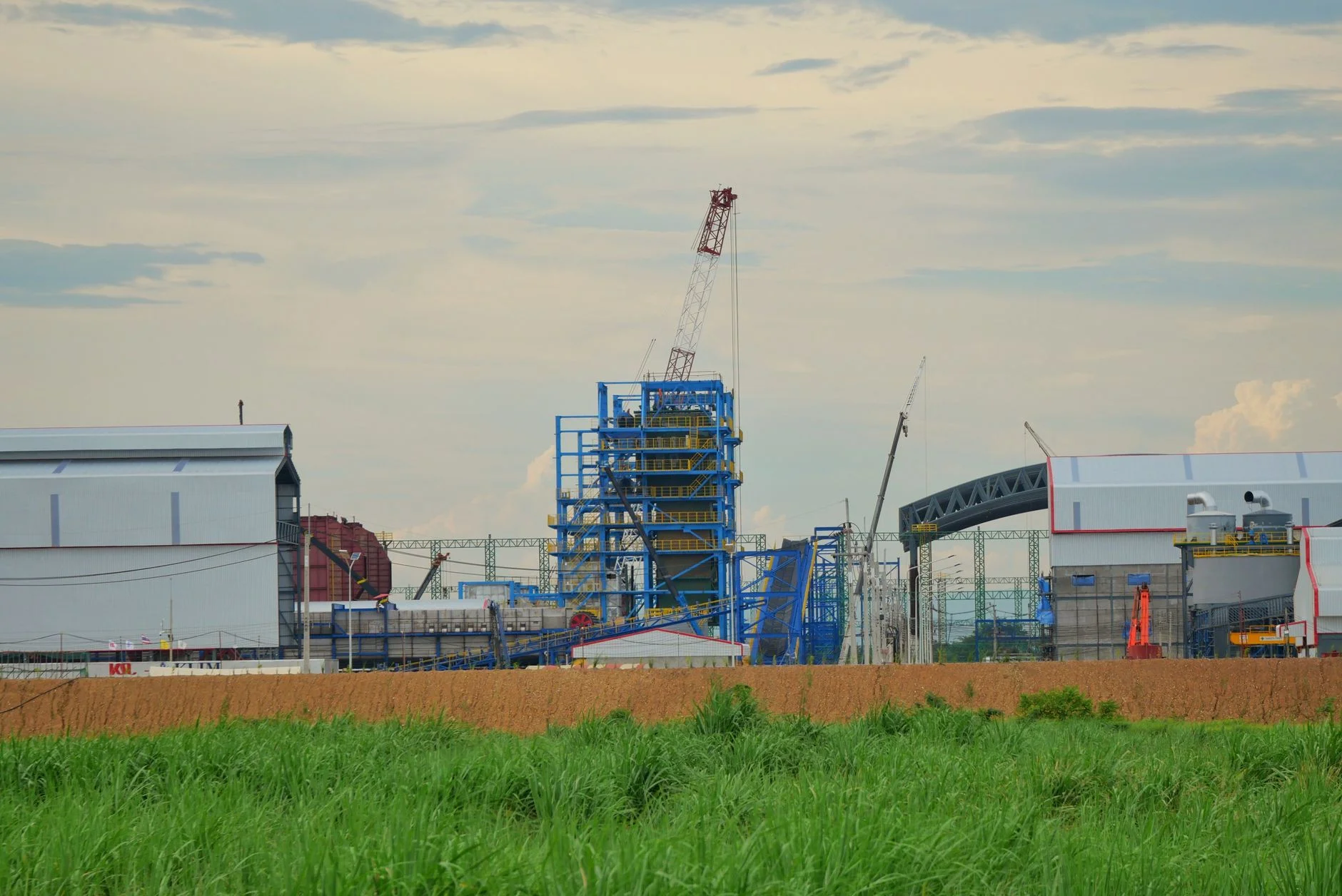Large industrial plant under construction with cranes and steel structures, the kind of turnkey scope an EPC RFP puts out to tender