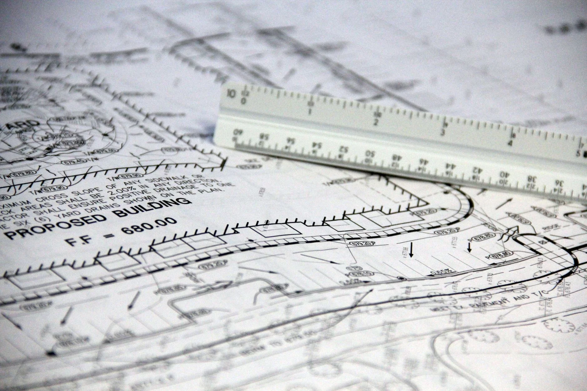 Dense technical drawings with a scale ruler, representing the kind of structured document industrial PDF parsing has to read